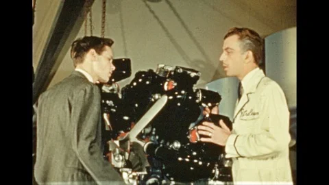 1930s: Actors speak on stage.  Machine.  Crowd watches animatronic oxen pull Stock Footage 109246396