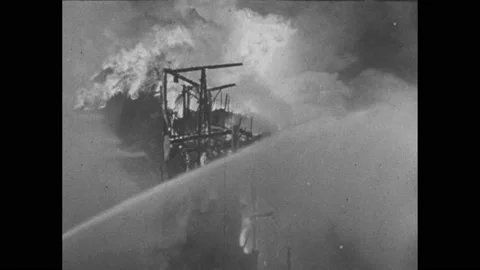1930s: Burning factory explodes and collapses. Leader. Cake on a table before a Vídeos de archivo 236172972
