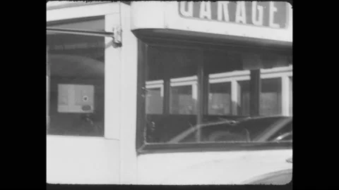 1930s: Bus in yard parks. 835 on side of a bus. Bus engine starts and runs. Bus Stock Footage 158967656