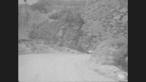 1930s: Car Drives Down Winding Mountain Road. Stock Footage