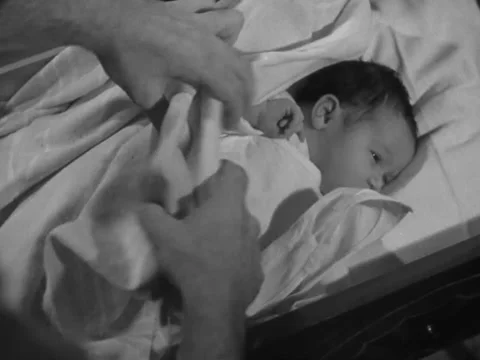 1930s: Checking baby's diaper Stock Footage 231920482