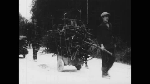 1930s: Children pull wagons. Men with weapons. Crowd. Men in uniform on balcony. Stock Footage 146247346