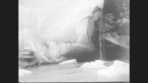 1930s: Close Ups Of Glacier. Man Carries Girl On Back Over Rocks. Man Helps Stock Footage