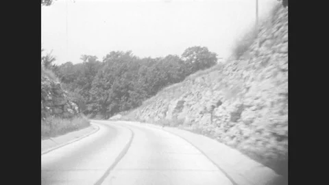1930s: Driving Down Road. Road Signs For: Iowa Us 20, Detour 161, Iowa Us 55. Stock Footage