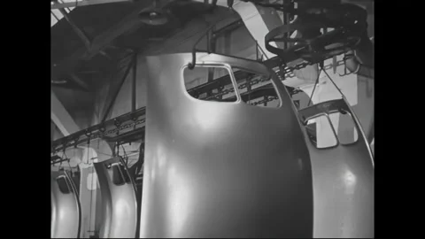1930s: Efficient hook conveyor transports car roofs through factory workshop Stock Footage 158819144