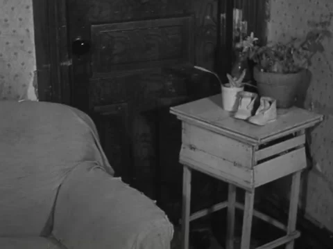 1930s: Empty couch, peeling wallpaper Stock Footage 231920439