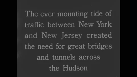 1930s: Intertitle. View of George Washington Bridge. Cars driving onto bridge. Video stock 164976662