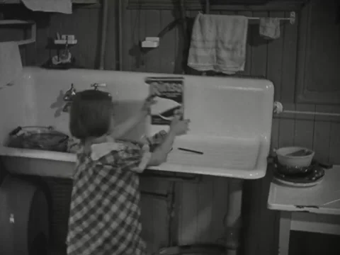 1930s: Kids help mom do dishes Stock Footage 231921705