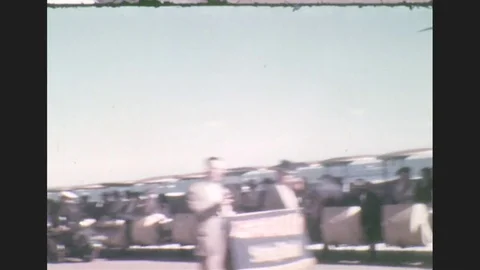 1930s: Large string band with sparkly outfits and headdresses plays and walks a Stock Footage