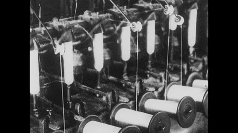 1930s: Machines wind string onto spools.  Man climbs ladder.  Men work in mine. Stock Footage 95333008