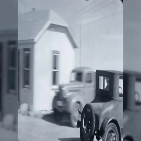 1930s Man Drives Antique Old Car Around Gas Station Vintage Old Film Home Movie Stock Footage
