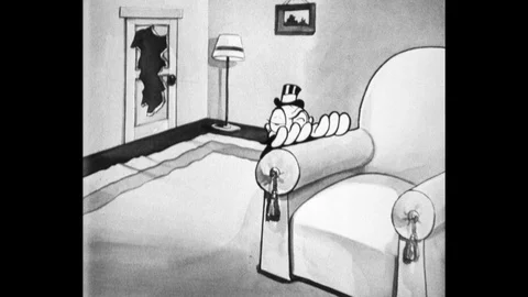 1930s: Man ducks flying objects behind chair. Small man enters house and sees Stock Footage 112522907