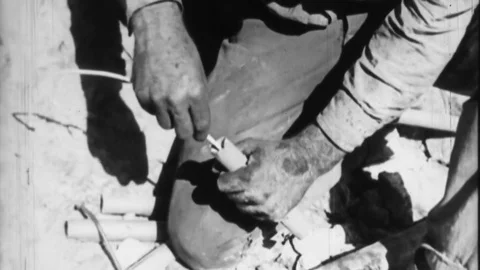 1930s Man Lights DYNAMITE MINING TNT Cap Blast ORE Vintage Film Industrial Movie Stock Footage