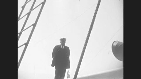 1930s: Man In Uniform Aboard Ship. Crew Untying Lifeboat. Stock Footage