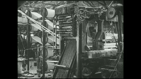 1930s -  Man works at giant loom in factory. Stock Footage