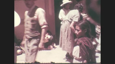 1930s: Men and women walk down city sidewalk. Stock Footage