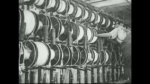 1930s -  Men check asbestos processing machines. Stock Footage 74688999