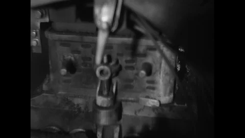 1930s: Men remove mold from bin, pull objects out of bin, push bin away, adjust Stock Footage 93278634
