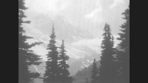 1930s: Mountain View. Girl Lies Back On Ground With Hands Behind Head. Peak. Stock Footage