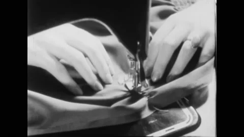 1930s: Person fixes pipe, turns valve, steers car. Woman sews clothes, writes, Stock Footage 217559656