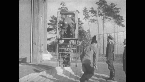 1930s: Soldiers jumping from platform onto padding. Soldier jumps from platform. Stock Footage 152534015