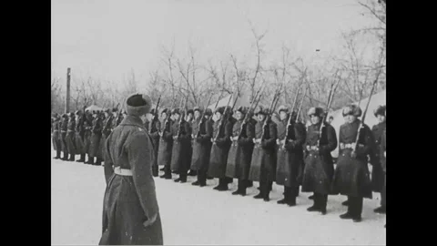 1930s - Soviet soldiers make their way through a wintry forest, where civilians Stock Footage 124180842