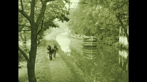 1930s: Two mules pull a barge down the Erie Canal. Commemorative sign Stock Footage 119481979