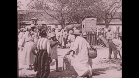 1930s: UNITED STATES: people in Port Au Prince, Haiti. Ladies in market. Ladies Stock Footage