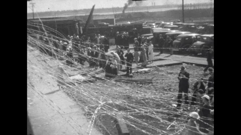 1930s: View from boat, passengers wave to crowd on pier. Tracking shot, pulling Stock Footage 113188565