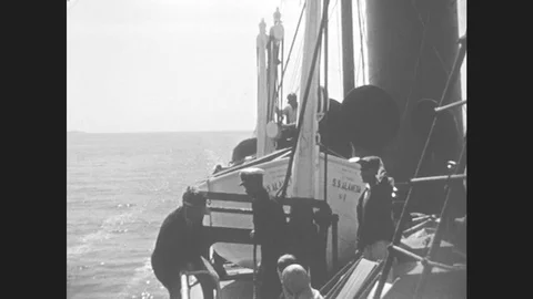 1930s: View From Ship, Crew Lowering Lifeboat. Stock Footage