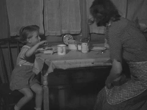 1930s: Young boy eats at kitchen table Stock Footage 231919915
