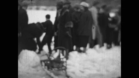 1930s:Dogs pull dog sled into crowd of people outside. Crowd of people stand and Stock Footage 236169505