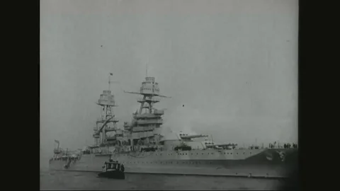 1931 - A blimp flies over the USS Arizona, sailing on choppy seas. Video stock 84789206