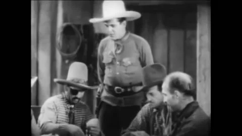 1931 - In this Pre-Code American Western film, a group of cowboys play cards at Stock Footage 217370433
