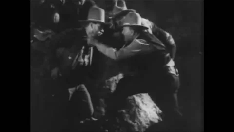 1931 - In this Pre-Code American Western film, a group of cowboys hide behind a Stock Footage 217370796