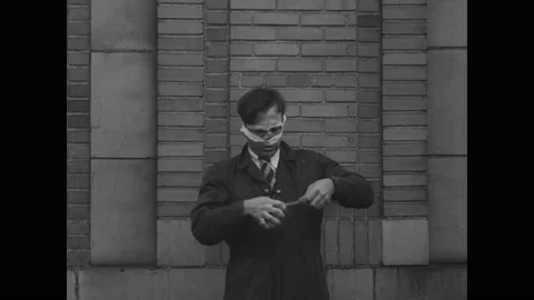 1932 - A daredevil puts on a parachute to prepare for jumping off a bridge. Video stock 248300426