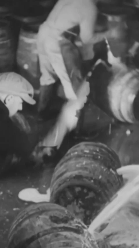 1932 - Law enforcement uses axis to destroy barrels of beer during Prohibition. Video stock 287568786