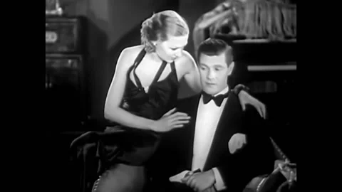 1932 - In this pre-code musical comedy, a woman tries to convince a man to be Stockbeeldmateriaal 246360352