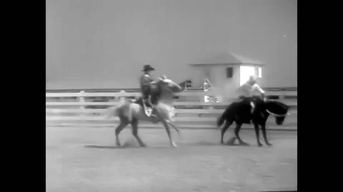 1932 - In this pre-code musical comedy, a woman rides a bucking bronco and is Stock Footage 246363152