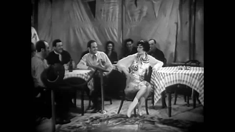 1932 - In this pre-code musical comedy, a man pulls a woman down off her feet Stock Footage 246364801