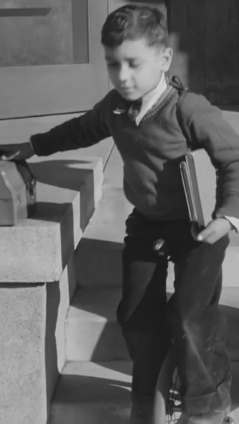 1933 - A boy rides a unicycle to school. Stock Footage 287576868