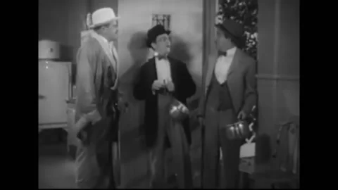 1933 - In this comedy, a man opens his door for two pushy pots and pans Stock Footage 226600739