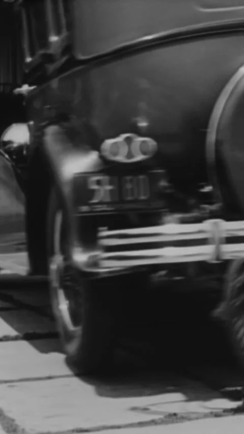 1933 - A driver parallel parks easily with the invention of a fifth wheel that Stock-Footage 287569820