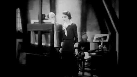 1933 - In this pre-code comedy, a painter shows a woman his painting and she is Stock Footage 246363188
