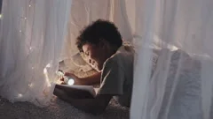 Boy Reading in Pillow Fort