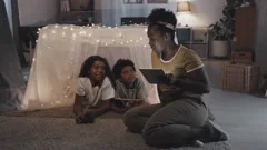 Woman Reading to Kids in Blanket Fort
