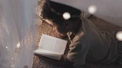 Kid Reading in Pillow Fort