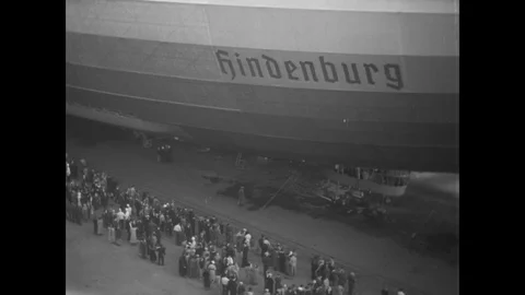1936 - Crowds admire the Hindenburg while it is in a hangar at a US Naval Air Stock Footage 129450254