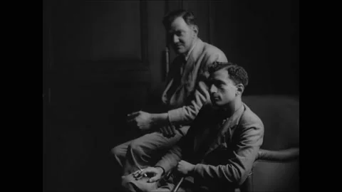 1936 - Men wait to be seen at the US Ambassador in Paris. Video stock 234502162