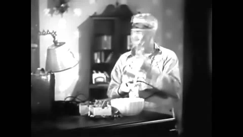 1937 - In this comedy, a man is building a small bomb. He places it under a Stock Footage 232882697